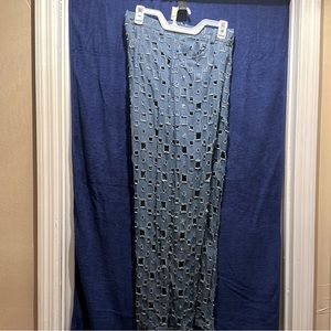 Women’s jeans, small squared holes meticulously placed all over.